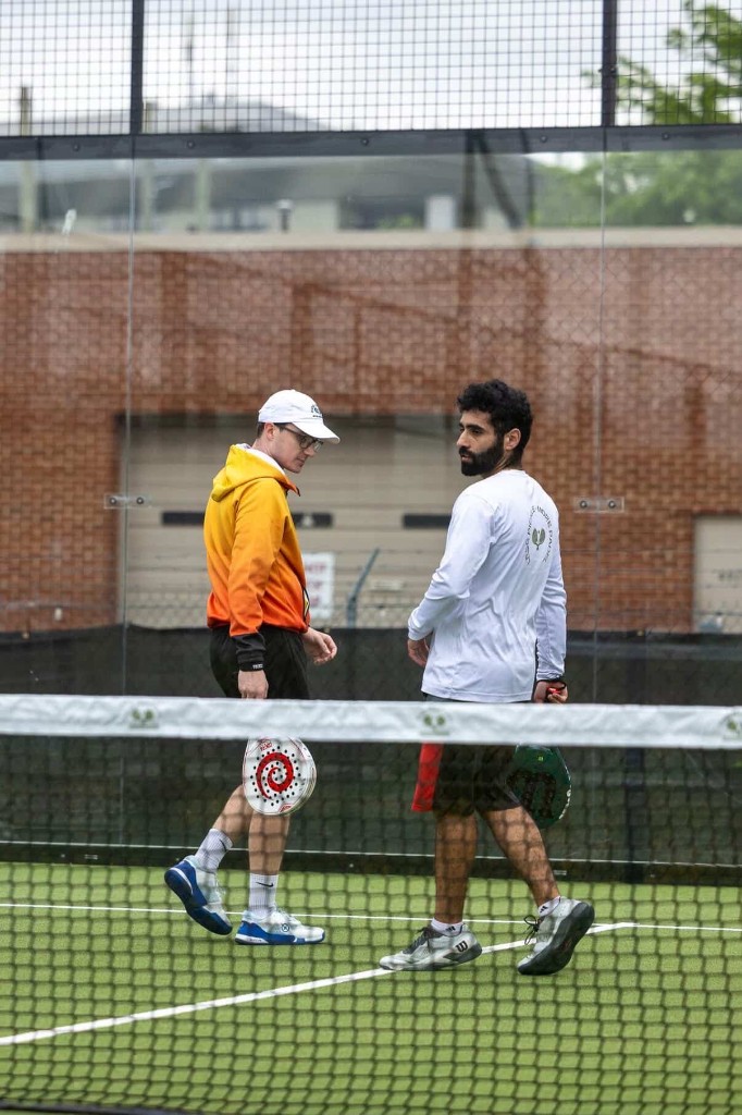 Padel players socializing at Glassbox Padel Club in College Park